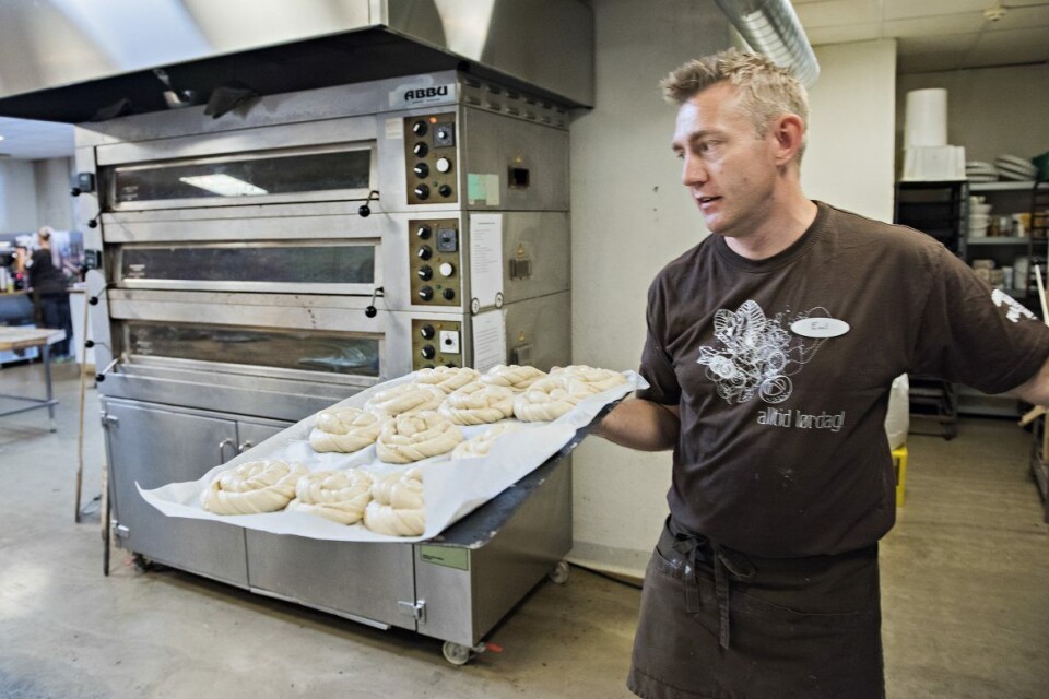 Baker ved Drømmeplassen i Kristiansand, Emil Lysø, klargjør et brett med store, saftige kanelsnurrer.