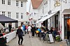 People visit Old Town of Mandal. It is an old fishing harbor in Vest-Agder county of Norway.